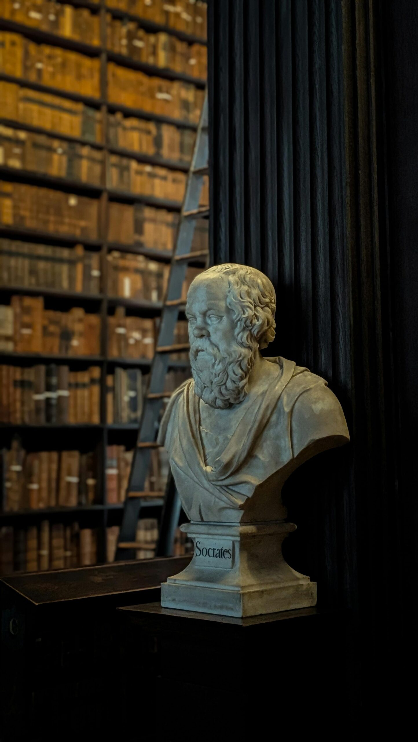 Home Classical Socrates bust in Dublin library with vintage bookshelves. Perfect for history and education themes.